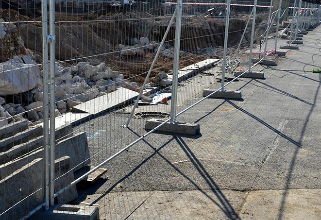 assorted temporary fence panels used for crowd control at lively concerts