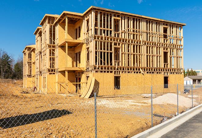 a temporary chain link fence in front of a building under construction, ensuring public safety in Pacoima